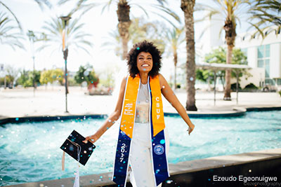 Graduate in front of fountain