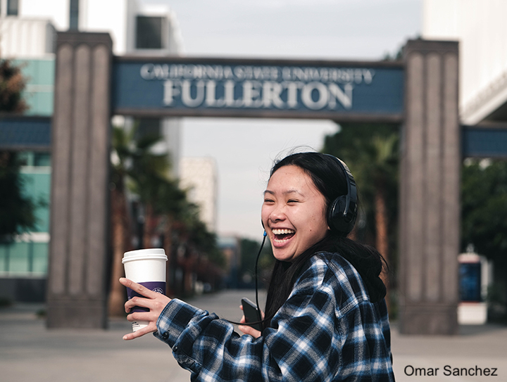 Student with coffee in walkway